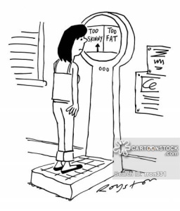Woman stands on scales which have two categories: Too Skinny / Too Fat.
